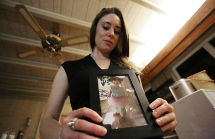 In this Feb. 13, 2017 photo, Casey Anthony poses with a photo of her daughter Caylee during an interview in her West Palm Beach, Fla., home. Anthony, 30, opens up for the first time on-the-record about the death of her daughter in 2008. (AP Photo/Joshua Replogle)