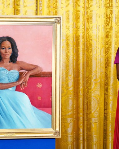 Former first lady Michelle Obama stands next to her official White House portrait during a ceremony in the East Room of the White House, in Washington. The former first lady chose artist Sharon Sprung to do her portrait
Biden Obama Portraits, Washington, United States - 07 Sep 2022