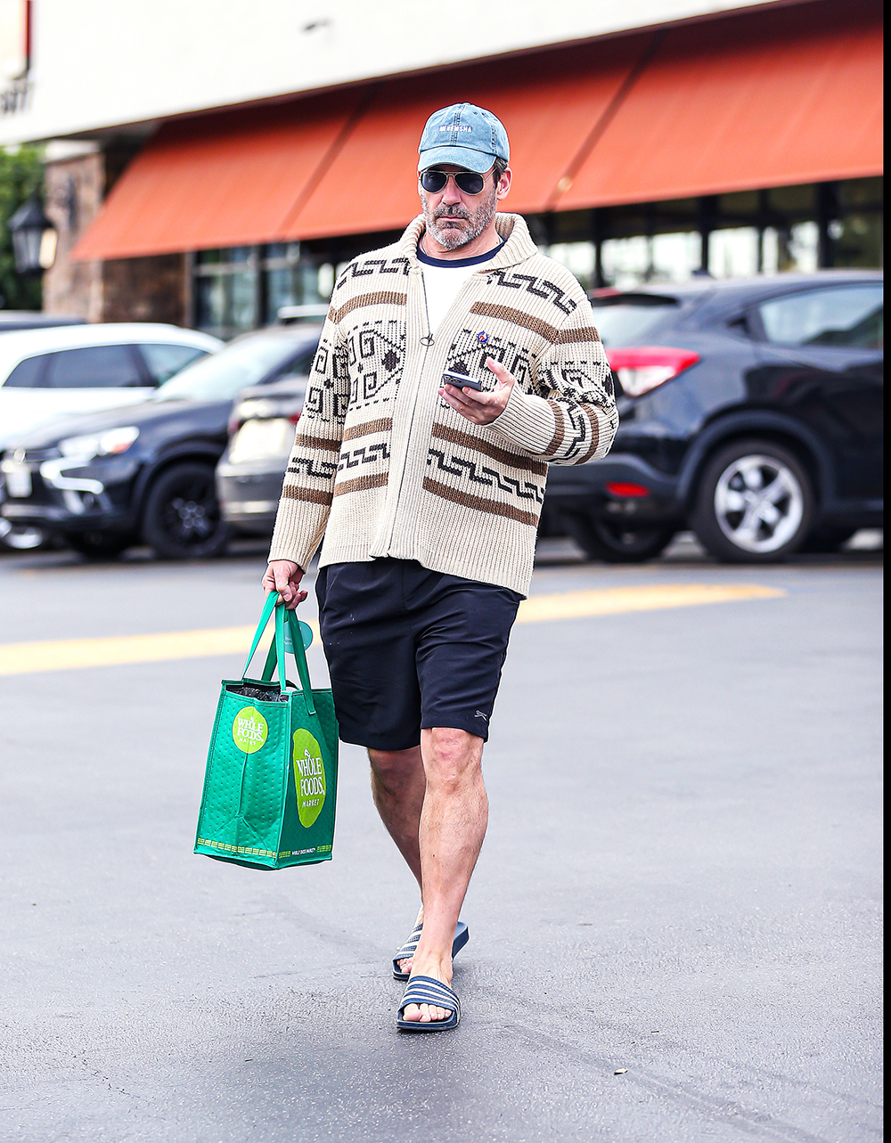 EXCLUSIVE: Jon Hamm Looked Cozingly Native In A Funky Sweater As He Grocery Shopped At Gelsons In Hollywood, CA. The Top Gun Star Was Seen Browsing The Aisles In Aviators and Flip Flops While Filling Up His Basket. 06 Jun 2022 Pictured: Jon Hamm. Photo credit: @CelebCandidly / MEGA TheMegaAgency.com +1 888 505 6342 (Mega Agency TagID: MEGA865788_028.jpg) [Photo via Mega Agency]