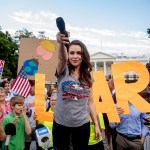 Actress Alyssa Milano holds out her microphone as she starts a chat while speaking at a protest outside the White House, in Washington. This is the second day in a row the group has held a protest following President Donald Trump's meetings with Russian President Vladimir PutinTrump, Washington, USA - 17 Jul 2018