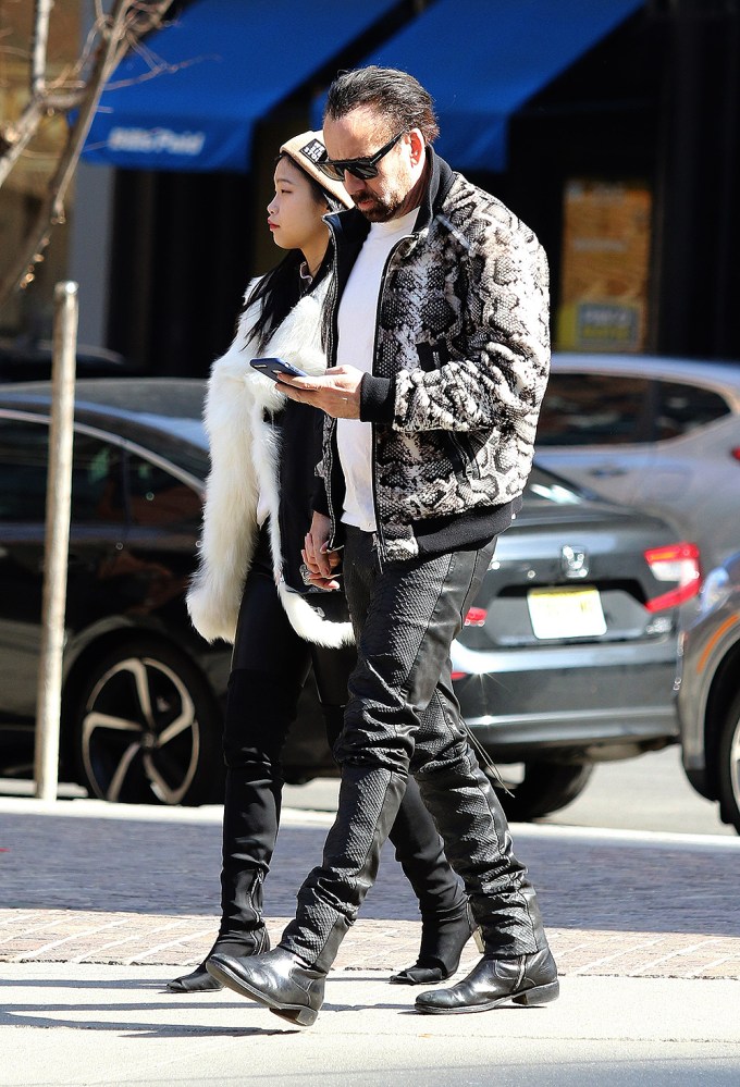 Nicolas Cage and girlfriend Riko Shibata hold hands