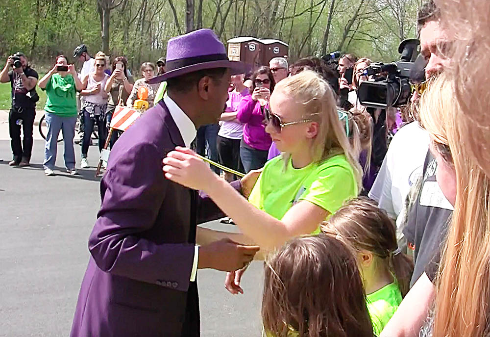 Larry Graham and Prince's friends hug fans outside the Paisley Park Studios