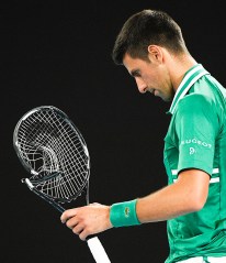 Serbia's Novak Djokovic walks to replace his smashed racket during his quarterfinal match against Germany's Alexander Zverev at the Australian Open tennis championship in Melbourne, Australia, Tuesday, Feb. 16, 2021.(AP Photo/Andy Brownbill)