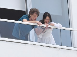 Rolling Stones frontman Mick Jagger and girlfriend Melanie Hamrick enjoy the view from their Miami Beach hotel balcony. The group was forced to reschedule their concert in the city for a second time as the arrival of hurricane Dorian draws near. 29 Aug 2019 Pictured: Mick Jagger; The Rolling Stones; Melanie Hamrick. Photo credit: MEGA TheMegaAgency.com +1 888 505 6342 (Mega Agency TagID: MEGA491268_002.jpg) [Photo via Mega Agency]