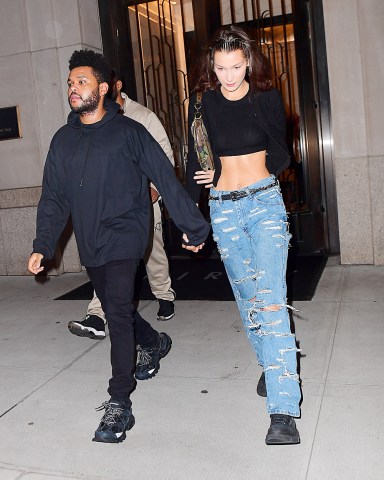 Bella Hadid and The Weeknd were spotted leaving her Manhattan NYC apartment on Friday night. The couple headed to dinner after reuniting following a busy Fashion Month for the Runway model. She flaunted her to-die-for abs in a crop top as they walked to their SUV. They were all smiles but they seemed to be playing coy about a large Diamond ring on Bella's hand. She hid one of her hands behind her back, while concealing an ENORMOUS diamond on the hand she had intertwined in the singer's. He covered the ring with 2 hands as they got into the car, just giving a quick glance at it.

Pictured: 
Ref: SPL5028849 280918 NON-EXCLUSIVE
Picture by: 247PAPS.TV / SplashNews.com

Splash News and Pictures
Los Angeles: 310-821-2666
New York: 212-619-2666
London: 0207 644 7656
Milan: +39 02 4399 8577
Sydney: +61 02 9240 7700
photodesk@splashnews.com

World Rights, No Portugal Rights