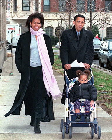 **FILE** Illinois state Sen. Barack Obama, D-Chicago, walks with his wife, Michelle, and daughter, Malia, age 1 1/2, in Chicago on primary day in Illinois in this March 21, 2000, file photo. Obama lost to incumbent U.S. Rep Bobby Rush in the election. (AP Photo/Chicago Sun-Times, Scott Stewart, File)  **CHICAGO OUT, MAGS OUT**