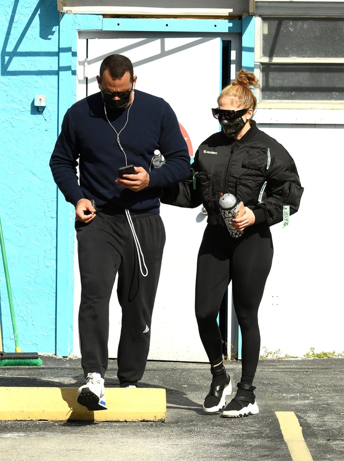 Jennifer Lopez and finance Alex Rodriguez twin in black workout gear.