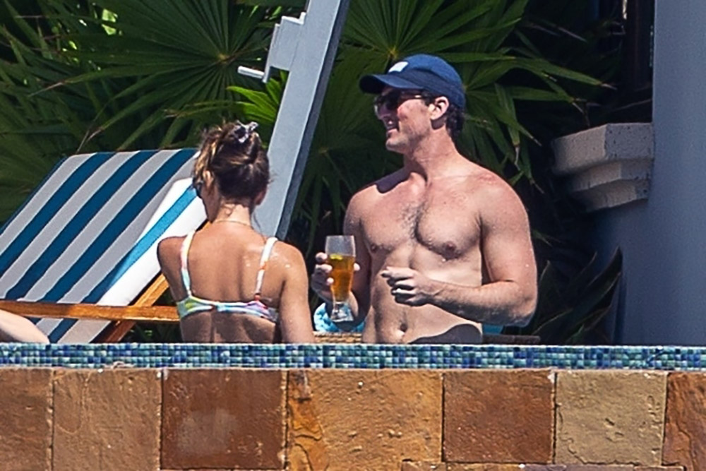 Top Gun star Miles Teller goes shirtless as he soaks up the sun and cuddles his model wife Keleigh Sperry during a lavish getaway to Mexico