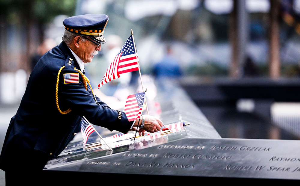 Sam Pulia, of Westchester, Ill., a former police officer,  fixes an American flag to names at the South Pool of the 9/11 Memorial during ceremonies marking the 17th anniversary of the terrorist attacks in New York, New York, USA, 11 September 2018.
17th Anniversary of 9/11 terror attack in New York, USA - 11 Sep 2018