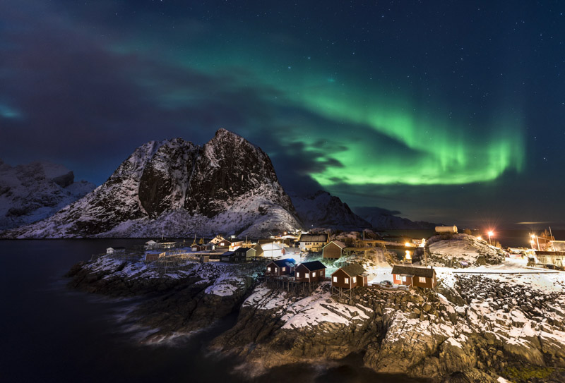 Town and fisherman's cabins or Rorbus in front of snowy mountains, aurora borealis, winter, Sakrisoeya, Moskenesoey, Lofoten, Norway
VARIOUS