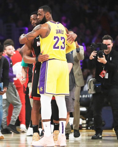 Los Angeles Lakers forward LeBron James (23) hugs ex teammate and current Miami Heat player Dwyane Wade during the first half of an NBA basketball game Monday, Dec. 10, 2018, in Los Angeles. (AP Photo/Marcio Jose Sanchez)