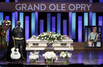 A Batman costume and guitar appear next to the casket during a memorial service for country music singer Troy Gentry at the Grand Ole Opry House, in Nashville, Tenn. Gentry, who was a fan of Batman and made up the duo Montgomery Gentry with Eddie Montgomery, died Sept. 8 in a helicopter crash
Troy Gentry Memorial, Nashville, USA - 14 Sep 2017