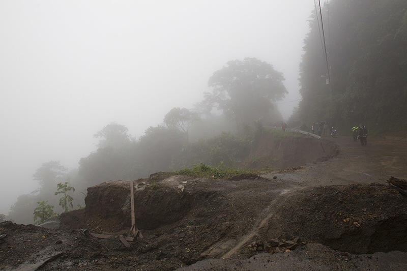 Neighbors walk under the rain past a washed out road in Alajuelita on the outskirts of San Jose, Costa Rica, Thursday, Oct. 5, 2017. Tropical Storm Nate formed off the coast of Nicaragua on Thursday and was being blamed for at least 17 deaths in Central America as it spun north toward a potential landfall on the U.S. Gulf Coast as a hurricane over the weekend. (AP Photo/Moises Castillo)