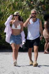 Bikini clad Amelia Hamlin happily applies sunscreen to boyfriend Scott Disick as they relax on the beach on Valentine's Day in Miami. 14 Feb 2021 Pictured: Scott Disick; Amelia Hamlin. Photo credit: MEGA TheMegaAgency.com +1 888 505 6342 (Mega Agency TagID: MEGA733444_003.jpg) [Photo via Mega Agency]