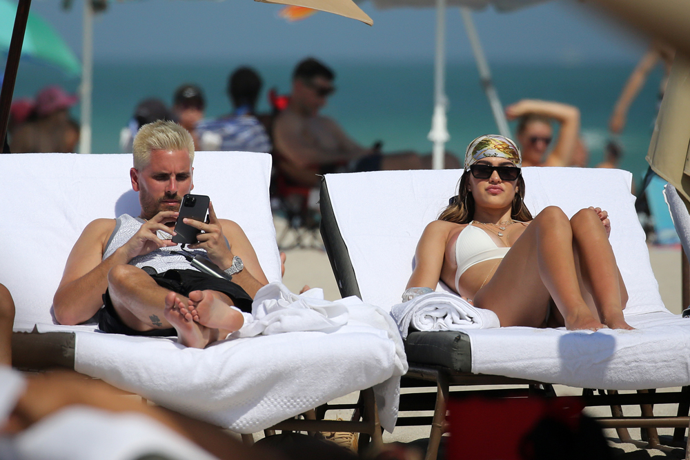 Amelia Hamlin shows off her curves in a white bikini as she hits the beach with boyfriend Scott Disick on Valentine's Day in Miami