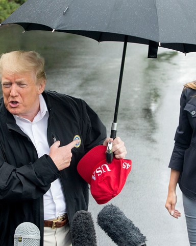 US President Donald J. Trump (L) delivers remarks to members of the news media beside First Lady Melania Trump (R), at the South Lawn of the White House before departing by Marine One, in Washington, DC, USA, 15 October 2018. Trump travels to the Florida Pandhandle and Georgia to view damage from Hurricane Michael. Before departing, Trump said he had spoken to the Saudi King Salman, regarding missing Washington Post contributor Jamal Khashoggi, and that US Secretary of State Mike Pompeo will meet with the Saudi King.
US President Donald J. Trump and First Lady Melania Trump depart the White House, Washington, USA - 15 Oct 2018