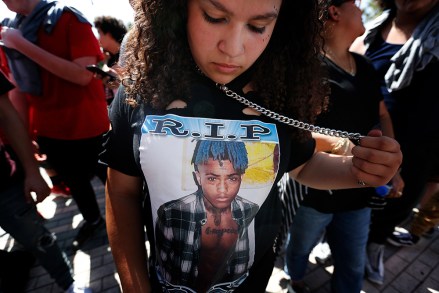 Fan Ayanna Gonzalez, 13, of New Jersey, wears a T-shirt in honor of the late rapper XXXTentacion as she waits in line for his memorial, in Sunrise, Fla. The rapper was gunned down in a luxury sports car last week
XXXTentacion Slain, Sunrise, USA - 27 Jun 2018