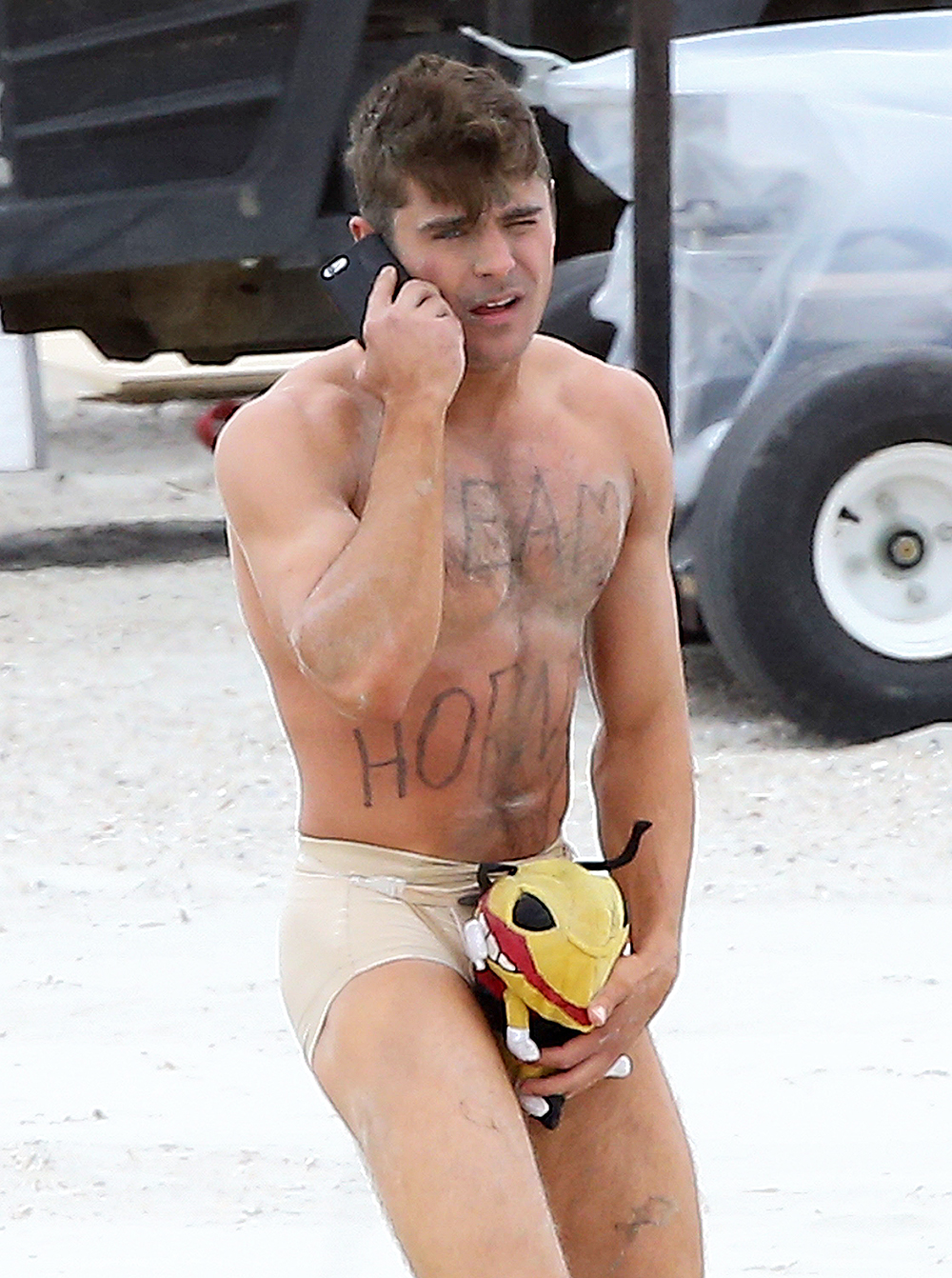 Actor Zac Efron strips down to his underwear to film a scene for his new movie 'Dirty Grandpa' in Tybee Island, Georgia.

Zac's character looks to have awoken naked on the beach after a night of partying, with only a stuffed animal to "hide his shame!" The words "Team Hornet" were written on his chest too!

UK RIGHTS ONLY

Pictured: Zac Efron
Ref: SPL4113654 280415 NON-EXCLUSIVE
Picture by: FameFlynet.uk.com / SplashNews.com

Splash News and Pictures
Los Angeles: 310-821-2666
New York: 212-619-2666
London: 0207 644 7656
Milan: +39 02 4399 8577
photodesk@splashnews.com

World Rights