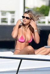 Sofia Richie shows off her voluptuous curves in a hot pink bikini as she takes a ride on a yacht with boyfriend Scott Disick in Miami. 25 Nov 2019 Pictured: Sofia Richie; Scott Disick. Photo credit: MEGA TheMegaAgency.com +1 888 505 6342 (Mega Agency TagID: MEGA556401_005.jpg) [Photo via Mega Agency]