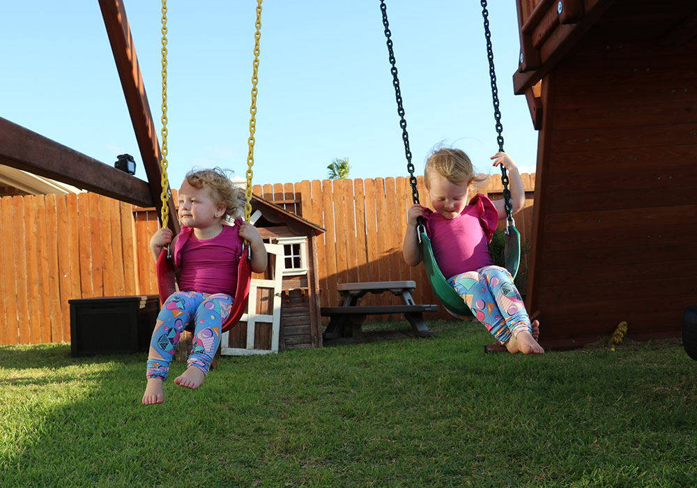 Olivia and Parker Busby are on the swing set.