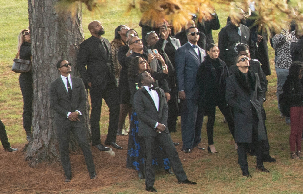 Sean 'Diddy' Combs and star-studded crowd of mourners gather to watch fireworks at Kim Porter's burial in Georgia.