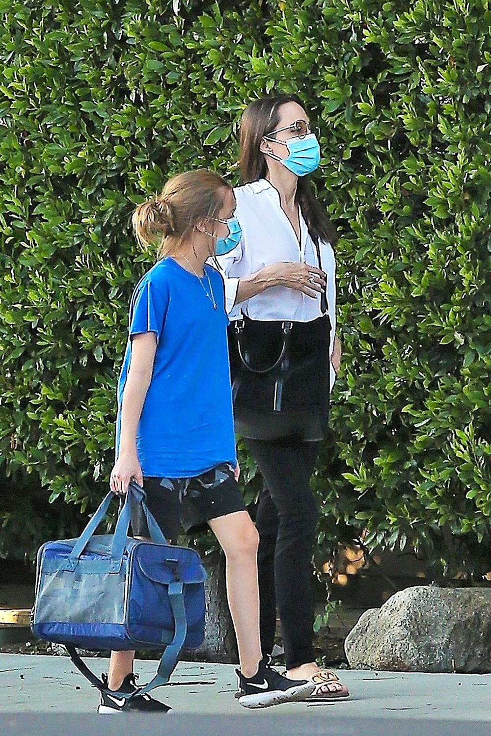 *EXCLUSIVE* A masked Angelina Jolie drops off her daughter Vivienne at a residence in LA