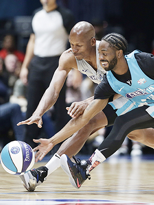 Home team's Famous Los, right, and Away team's Ray Allen chase the ball during the first half of an NBA All-Star Celebrity basketball game in Charlotte, N.C., Friday, Feb. 15, 2019. (AP Photo/Gerry Broome)