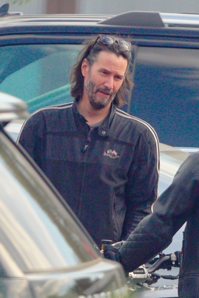 Keanu Reeves Cruises On A Motorcycle In Malibu