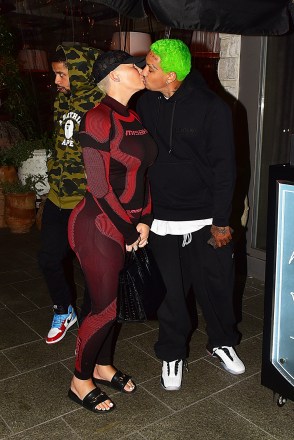 Los Angeles, CA  - Amber Rose and Alexander "AE" Edwards kiss for the cameras after dinner with a friend at Avra in Beverly Hills. The What Happened Last Night actress kept it simple in a black and red outfit. The leggings and long sleeve shirt had the same pattern and showed off her toned curves as her baby daddy rocked his signature neon green hair and a black sweatsuit.

Pictured: Amber Rose, Alexander "AE" Edwards

BACKGRID USA 19 DECEMBER 2019 

USA: +1 310 798 9111 / usasales@backgrid.com

UK: +44 208 344 2007 / uksales@backgrid.com

*UK Clients - Pictures Containing Children
Please Pixelate Face Prior To Publication*