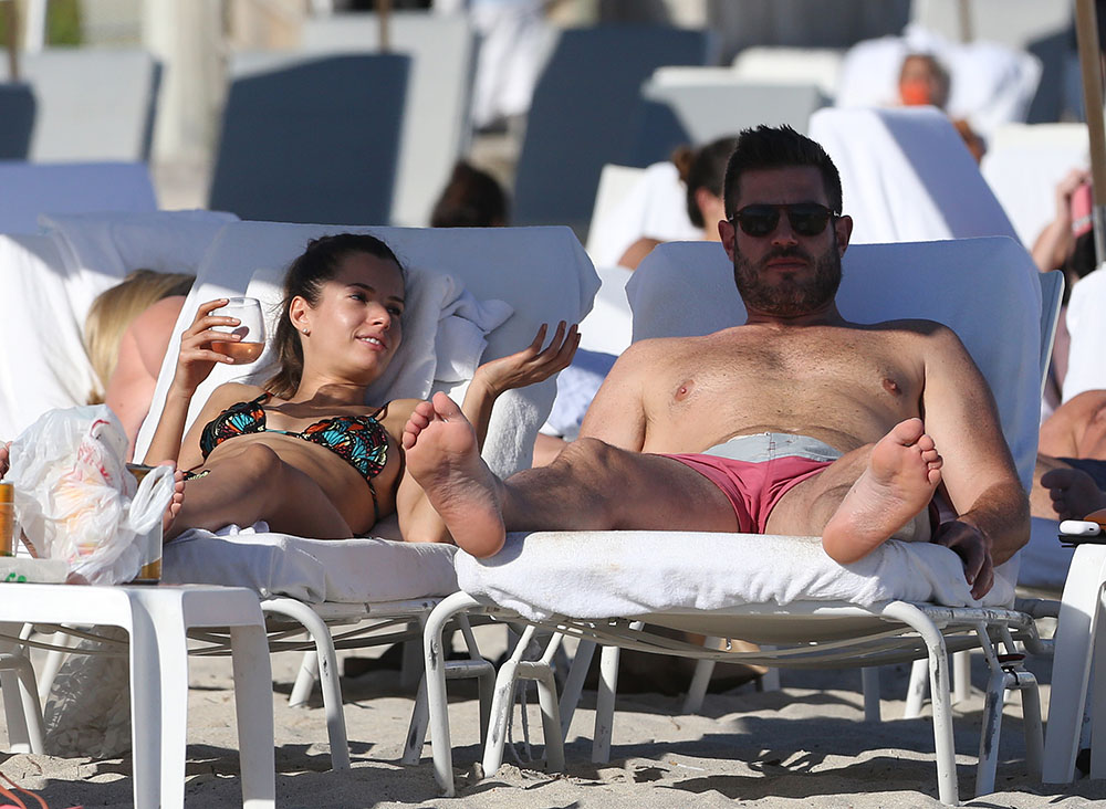 EXCLUSIVE: Canadian sports commentator Jesse Palmer and Brazilian model Emely Fardo drink rose wine and show PDA on the beach in Miami