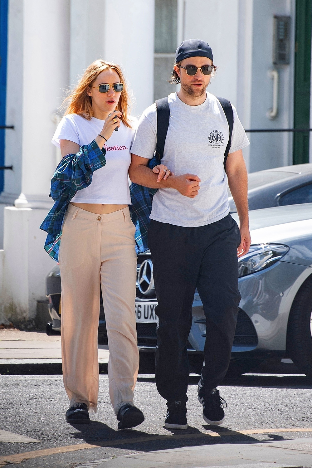 *EXCLUSIVE* London, UNITED KINGDOM  - Braless Suki Waterhouse spotted smoking an E-cigarette whilst walking with beau Robert Pattinson. The pair were spotted strolling in London looking loved up as they walk arm in arm. Suki was wearing a crop t shirt with Realistation printed on it and flared beige trousers. Whilst Robert sported his signature cap worn backwards and white t-shirt and baggy trousers.

Pictured: Suki Waterhouse, Robert Pattinson

BACKGRID USA 21 JULY 2020 

USA: +1 310 798 9111 / usasales@backgrid.com

UK: +44 208 344 2007 / uksales@backgrid.com

*UK Clients - Pictures Containing Children
Please Pixelate Face Prior To Publication* *CLIENT RESTRICTION APPLIED*