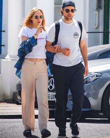 *EXCLUSIVE* London, UNITED KINGDOM  - Braless Suki Waterhouse spotted smoking an E-cigarette whilst walking with beau Robert Pattinson. The pair were spotted strolling in London looking loved up as they walk arm in arm. Suki was wearing a crop t shirt with Realistation printed on it and flared beige trousers. Whilst Robert sported his signature cap worn backwards and white t-shirt and baggy trousers.

Pictured: Suki Waterhouse, Robert Pattinson

BACKGRID USA 21 JULY 2020 

USA: +1 310 798 9111 / usasales@backgrid.com

UK: +44 208 344 2007 / uksales@backgrid.com

*UK Clients - Pictures Containing Children
Please Pixelate Face Prior To Publication* *CLIENT RESTRICTION APPLIED*