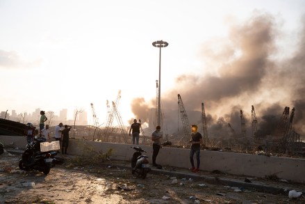 Aftermath of a massive explosion is seen in in Beirut, Lebanon, Tuesday, Aug. 4, 2020. Massive explosions rocked downtown Beirut on Tuesday, flattening much of the port, damaging buildings and blowing out windows and doors as a giant mushroom cloud rose above the capital. Witnesses saw many people injured by flying glass and debris. (AP Photo/Hassan Ammar)