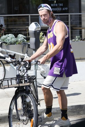 Brentwood, CA  - *EXCLUSIVE*  - Lakers fan Patrick Schwarzenegger enjoys his iced coffee while going for a cruise on his E-bike around Brentwood.

Pictured: Patrick Schwarzenegger

BACKGRID USA 15 AUGUST 2020 

USA: +1 310 798 9111 / usasales@backgrid.com

UK: +44 208 344 2007 / uksales@backgrid.com

*UK Clients - Pictures Containing Children
Please Pixelate Face Prior To Publication*