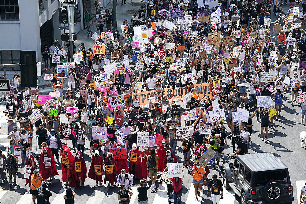 Demonstrators march during a Women's March Saturday, Oct. 17, 2020, in Los Angeles. Thousands of women rallied in U.S. cities, to oppose President Donald Trump and his fellow Republican candidates in the Nov. 3 elections. (AP Photo/Marcio Jose Sanchez)