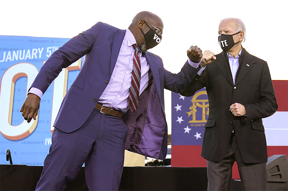 President-elect Joe Biden elbow bumps Senate candidate Raphael Warnock in Atlanta, Monday, Jan. 4, 2021, during a campaign rally for Warnock and Jon Ossoff. (AP Photo/Carolyn Kaster)