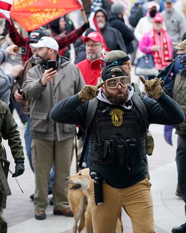 Trump supporters gather outside the Capitol, Wednesday, Jan. 6, 2021, in Washington. As Congress prepares to affirm President-elect Joe Biden's victory, thousands of people have gathered to show their support for President Donald Trump and his claims of election fraud. (AP Photo/Manuel Balce Ceneta)