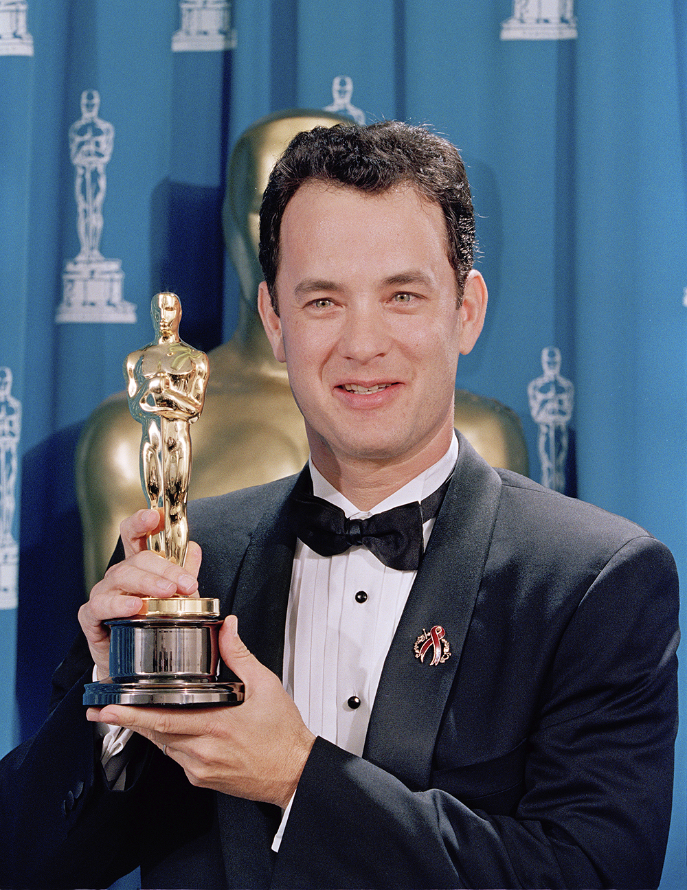 Tom Hanks holds his first Oscar backstage at the 66th Academy Awards ceremony held at the Dorothy Chandler Pavilion in Los Angeles, March 21, 1994. Tom Hanks won the Best Actor Oscar for his role as Andrew Beckett in the movie Philadelphia. (AP Photo/NewsBase)