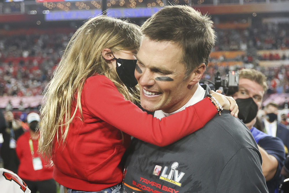 Tampa Bay Buccaneers quarterback Tom Brady (12) celebrates with his family following the NFL Super Bowl 55 football game against the Kansas City Chiefs, Sunday, Feb. 7, 2021 in Tampa, Fla. Tampa Bay won 31-9 to win Super Bowl LV. (Ben Liebenberg via AP)