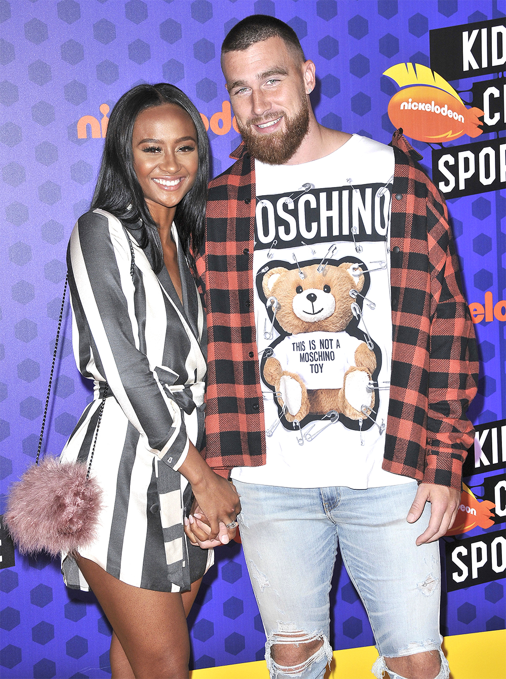 (L-R) Kayla Nicole and Travis Kelce arrives at the Nickelodeon's Kids' Choice Sports 2018 held at the Barker Hangar in Santa Monica, CA on Thursday, July 19, 2018. (Photo By Sthanlee B. Mirador/Sipa USA)(Sipa via AP Images)