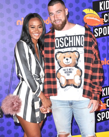 (L-R) Kayla Nicole and Travis Kelce arrives at the Nickelodeon's Kids' Choice Sports 2018 held at the Barker Hangar in Santa Monica, CA on Thursday, July 19, 2018. (Photo By Sthanlee B. Mirador/Sipa USA)(Sipa via AP Images)