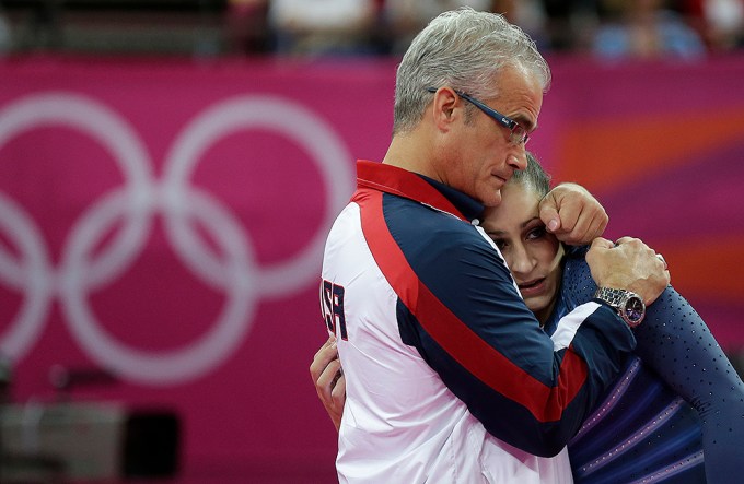 Jordyn Wieber being consoled by head coach John Geddert