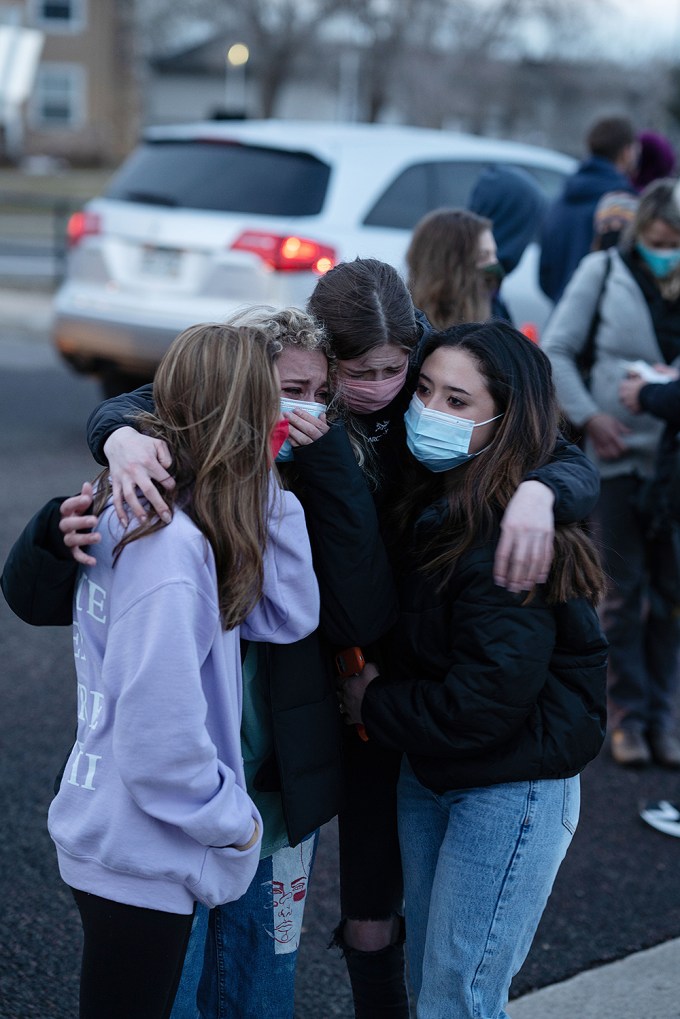 Friends Hold Each Other in Tears Mourning Those who Died