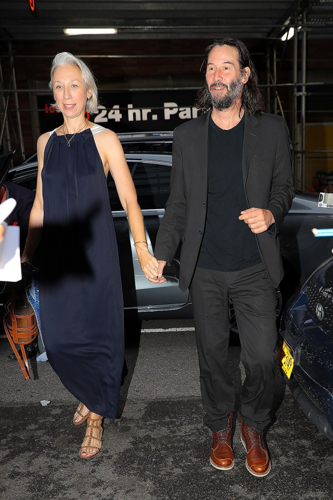 Keanu Reeves & Alexandra Grant hand in hand