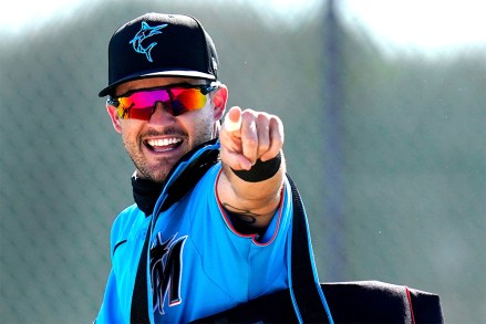 Miami Marlins' Eddy Alvarez points as he runs between fields during spring training baseball practice, in Jupiter, Fla
Marlins Spring Baseball, Jupiter, United States - 26 Feb 2021