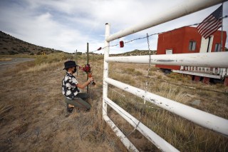 Woman, who did not want to give her name, places a flower bouquet at the entrance of the Bonanza Creek Film Ranch in Santa Fe, N.M., . An assistant director unwittingly handed actor Alec Baldwin a loaded weapon and told him it was safe to use in the moments before the actor fatally shot cinematographer Halyna Hutchins on the set of a Western, court records released Friday show
Prop Firearm Movie Set, Santa Fe, United States - 23 Oct 2021