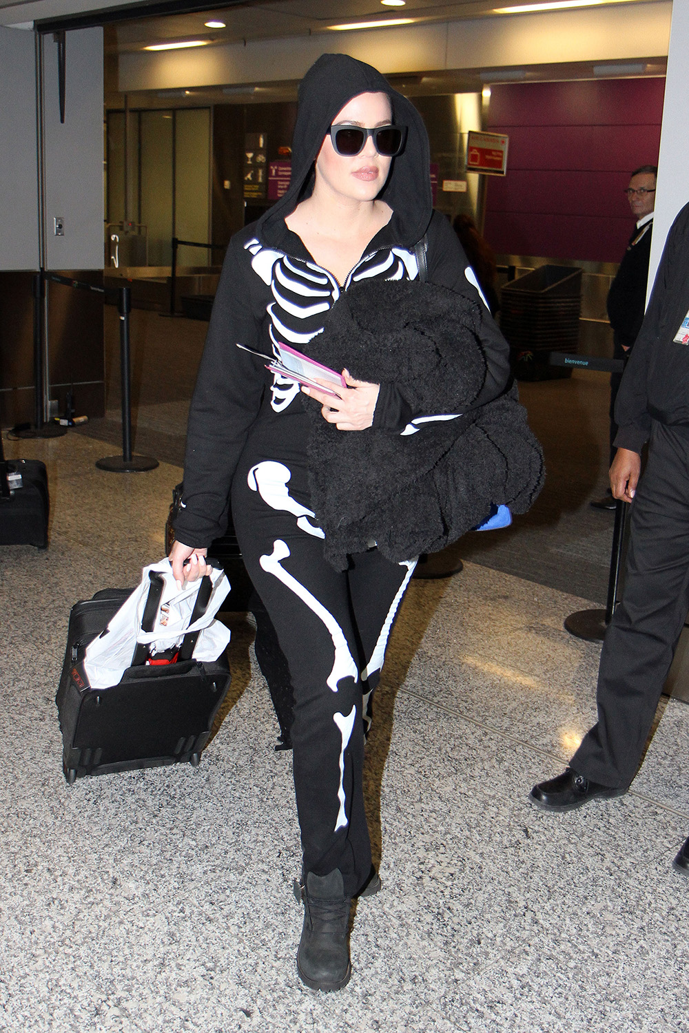 Khloe Kardashian arrives at Peason International Airport in Toronto, Canada on Halloween. Since it was Halloween, Khloe Kardashian was dressed in Costume wearing a Black Skeleton Onesie with Sunglasses while carrying her luggage around the airport. Khloe Kardashian was catching a connecting flight to Ottawa as she is hosting a Halloween Haunted Carnival Party with Scott Disick, Brody Jenner, Audrina Patridge, and Dennis Rodman.Pictured: Khloe KardashianRef: SPL876573 311014 NON-EXCLUSIVEPicture by: SplashNews.comSplash News and PicturesUSA: +1 310-525-5808London: +44 (0)20 8126 1009Berlin: +49 175 3764 166photodesk@splashnews.comWorld Rights