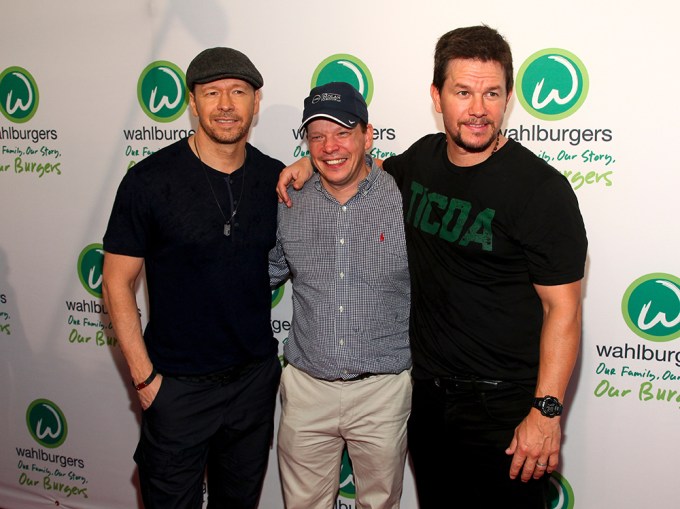 Donnie, Paul, & Mark Wahlberg pose at an event