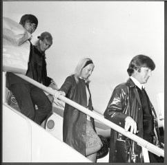 John Lennon His Wife Cynthia Lennon And Fellow Beatle George Harrison Disembark From A Plane As They Return From Their Holiday. John Lennon His Wife Cynthia Lennon And Fellow Beatle George Harrison Disembark From A Plane As They Return From Their Holiday.