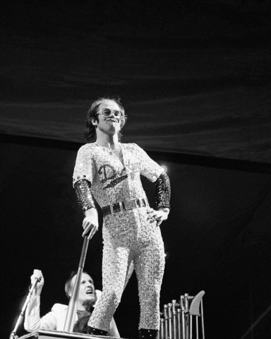 Editorial Use Only / Consent for book publication must be agreed with Rex Features before use
Mandatory Credit: Photo by Andre Csillag/Shutterstock (10196907ax)
Sir Elton John
Elton John in concert at Dodger Stadium, Los Angeles, USA
 - October 1975